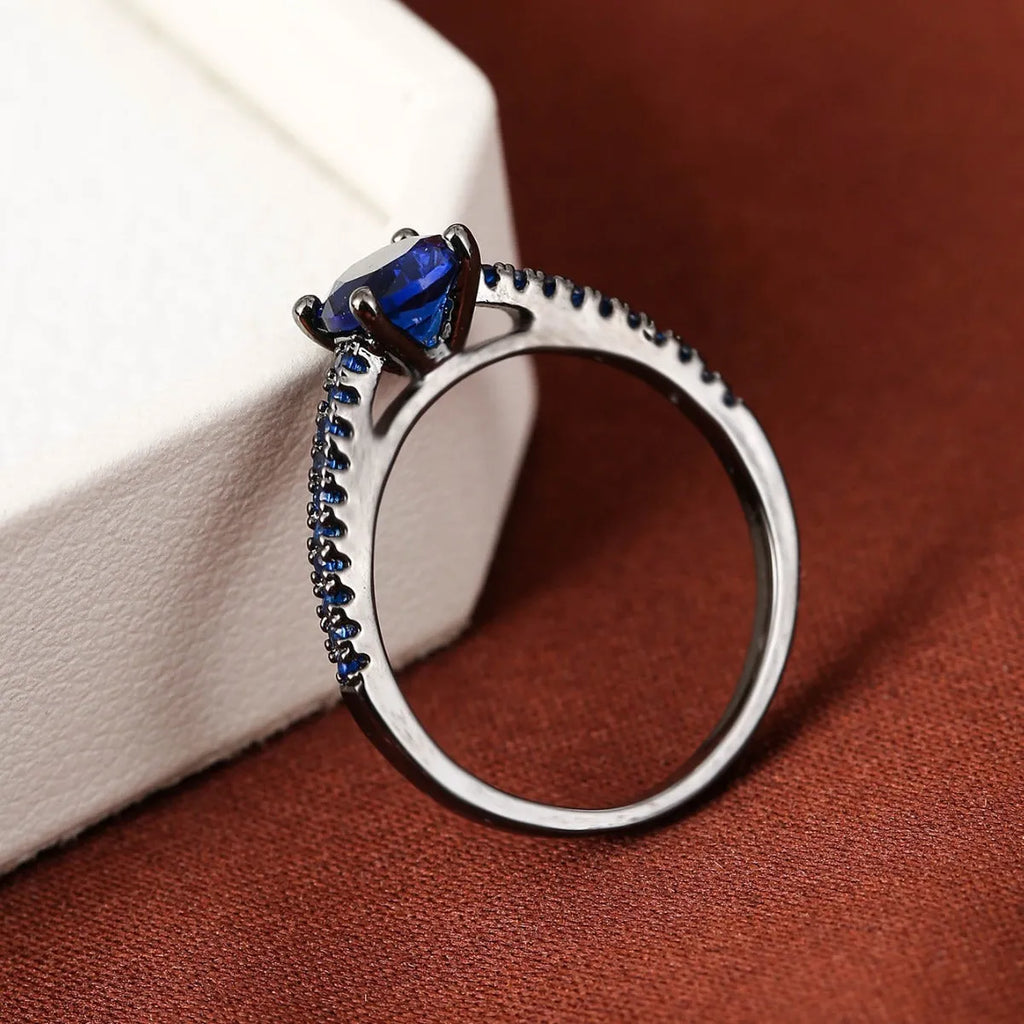 Colourful hexagonal zircon ring in copper with electroplated finish on a size 7 finger.