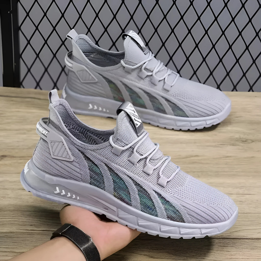 Low-top black mesh tennis sneakers with a plastic sole on a white background