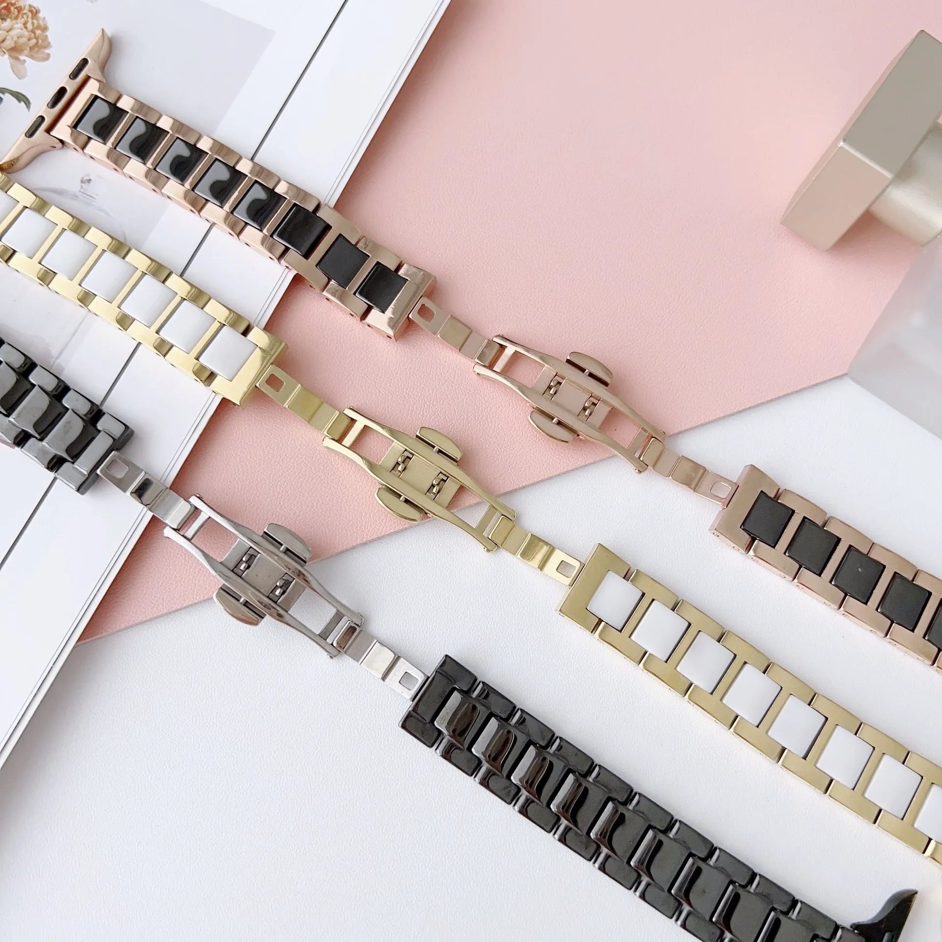 Stainless steel ceramic watch band for Apple Watch 38-49mm in gold with black ceramic finish on a wrist