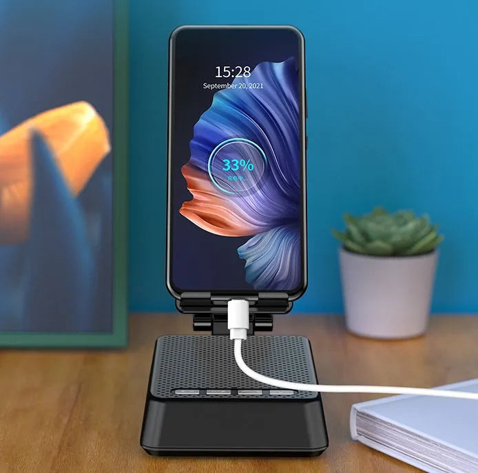 Black mobile phone broadcasting stand with Bluetooth speaker and microphone on desk