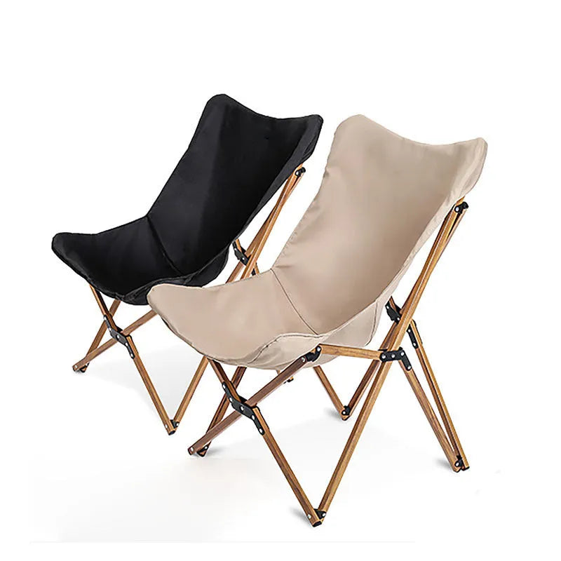 Folding camping chair with aluminium frame, wood grain finish, handrails, and rotating seat in outdoor setting