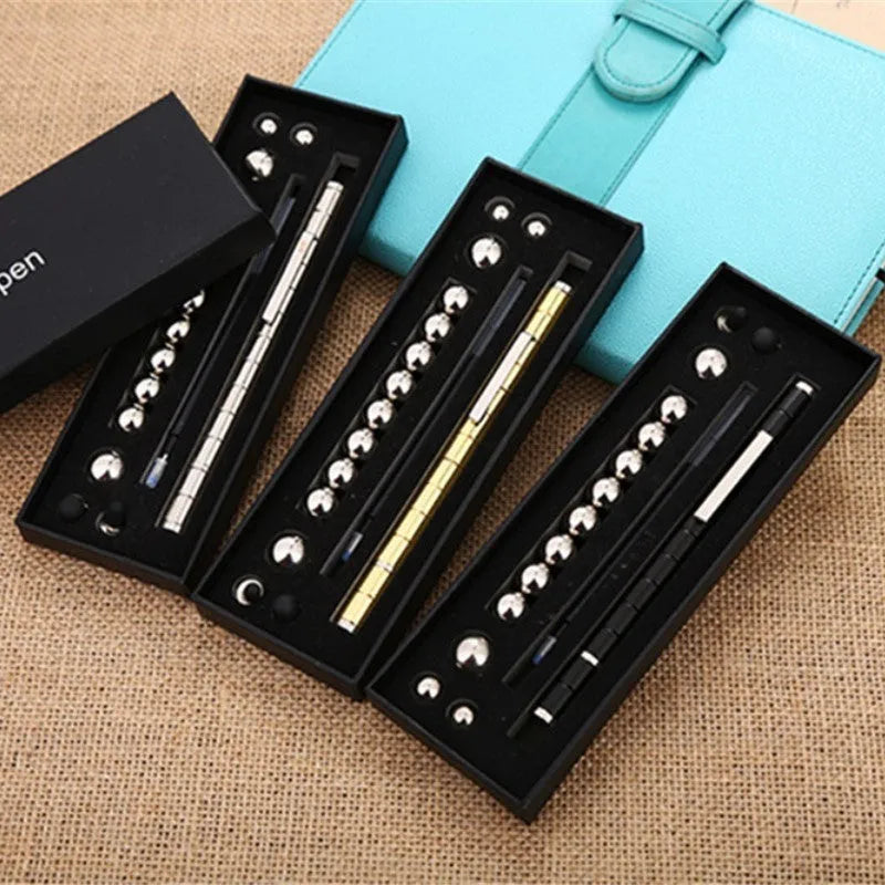 Magnetic modular fidget pen with silver finish, magnetic rings, steel balls, and capacitive head on a table