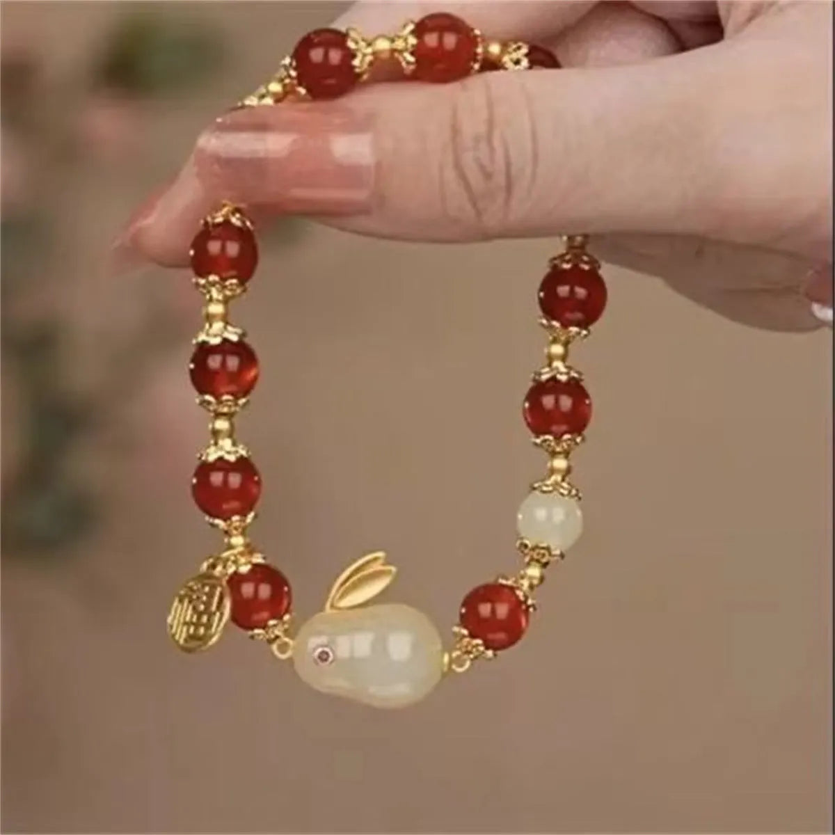 Peace buckle bracelet with a coloured glass rabbit charm on a simple band