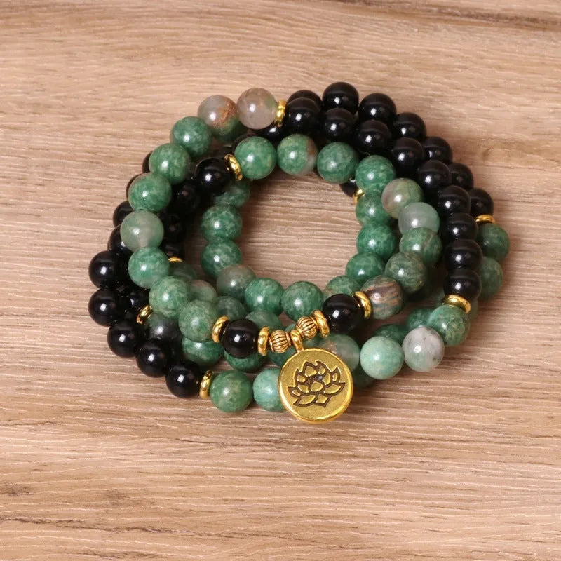 Green and black elastic beaded bracelet with alloy construction