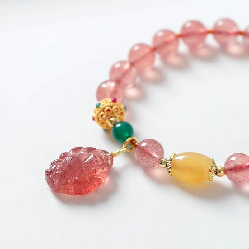 Women's crystal bracelet with nine tail fox design in polished natural strawberry quartz beads
