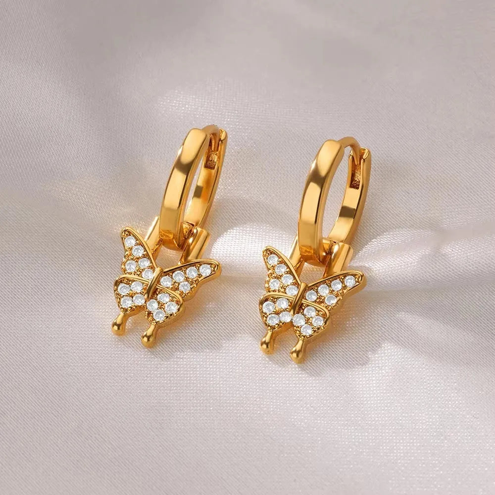 Women's geometric butterfly earrings in copper with heart and star details