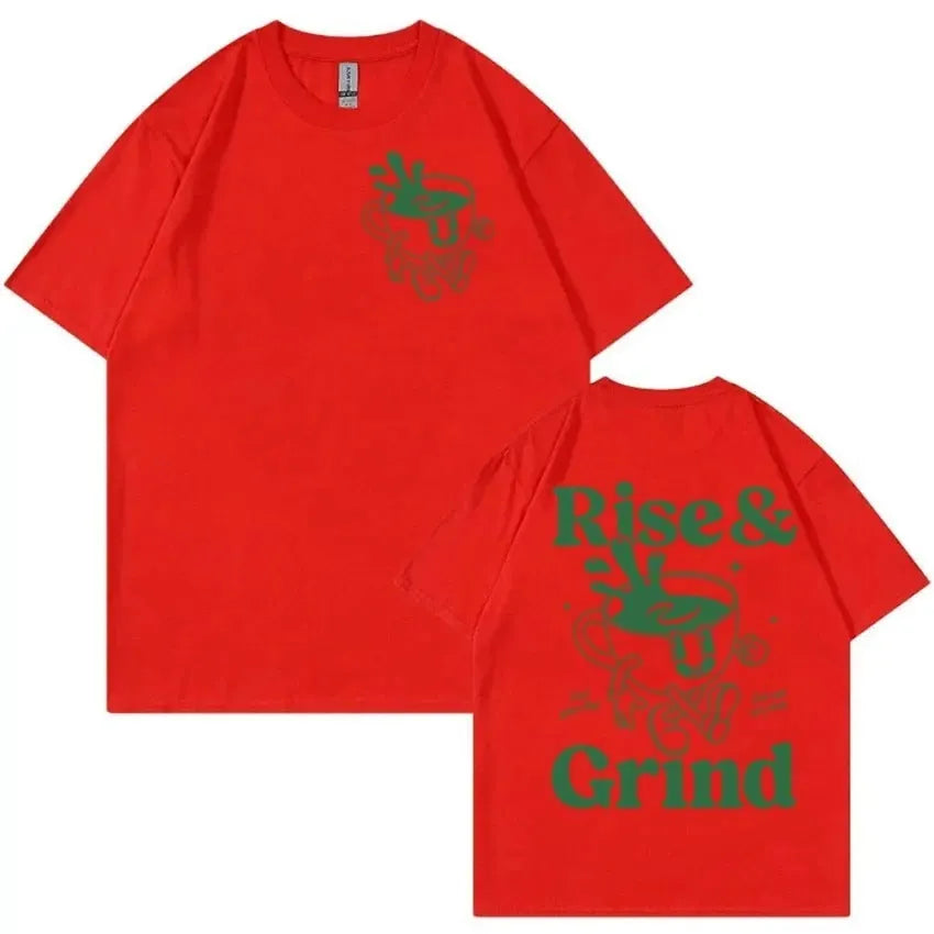 Man wearing a loose black linen t-shirt with a green 'Rise And Grind Green Coffee' cartoon graphic print.