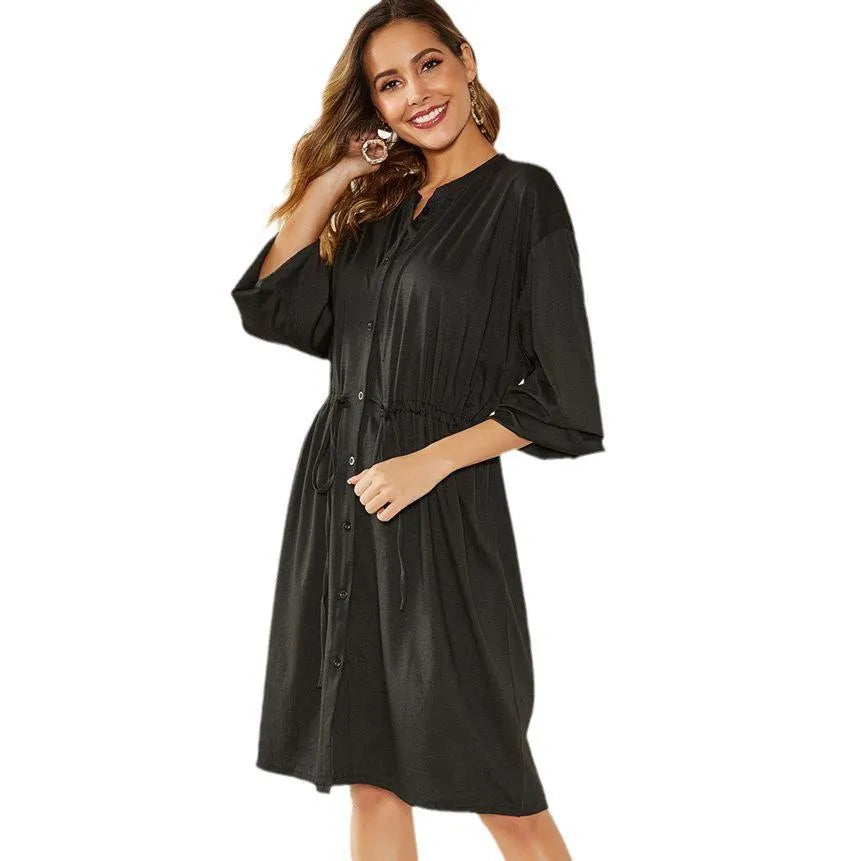 A black polyester cardigan dress with long sleeves, an elastic waist, and a removable cinch belt on a midi A-line skirt.