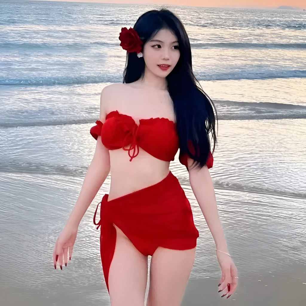 Red women's bikini swimsuit with puff sleeve top and solid briefs laid flat