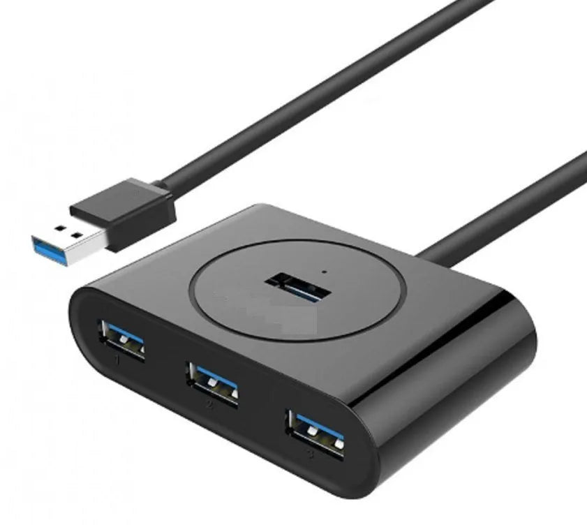 Deep black USB splitter hub with four ports, ABS plastic shell, and indicator light on desk