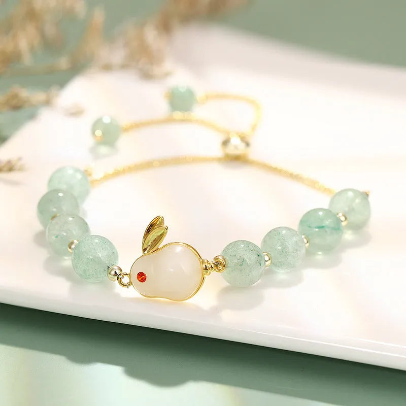 Women's rabbit design bracelet with green natural stones and copper gold accents