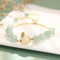 Women's rabbit design bracelet with green natural stones and copper gold accents