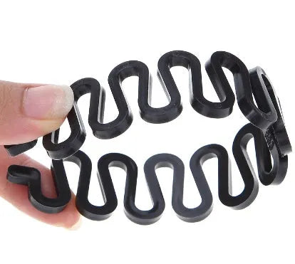 Set of four black plastic hair styling tools including pull hair needles, double hook plate needle, and French braiding tool on white background