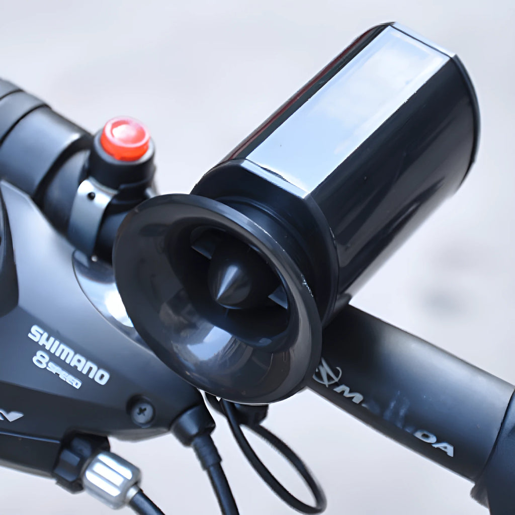 Black plastic bicycle electronic horn with push button on handlebar mount