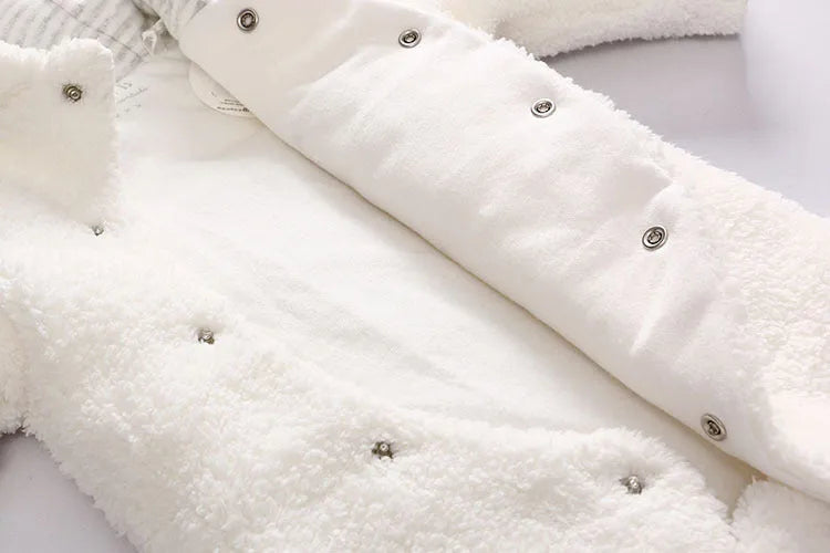 Brown cotton baby winter jumpsuit with covered feet and a front zipper.