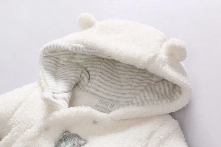 Brown cotton baby winter jumpsuit with covered feet and a front zipper.