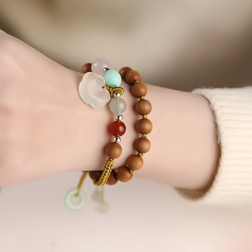 Hand-woven ebony wood bracelet with double ring design and traditional Chinese Ruyi elements