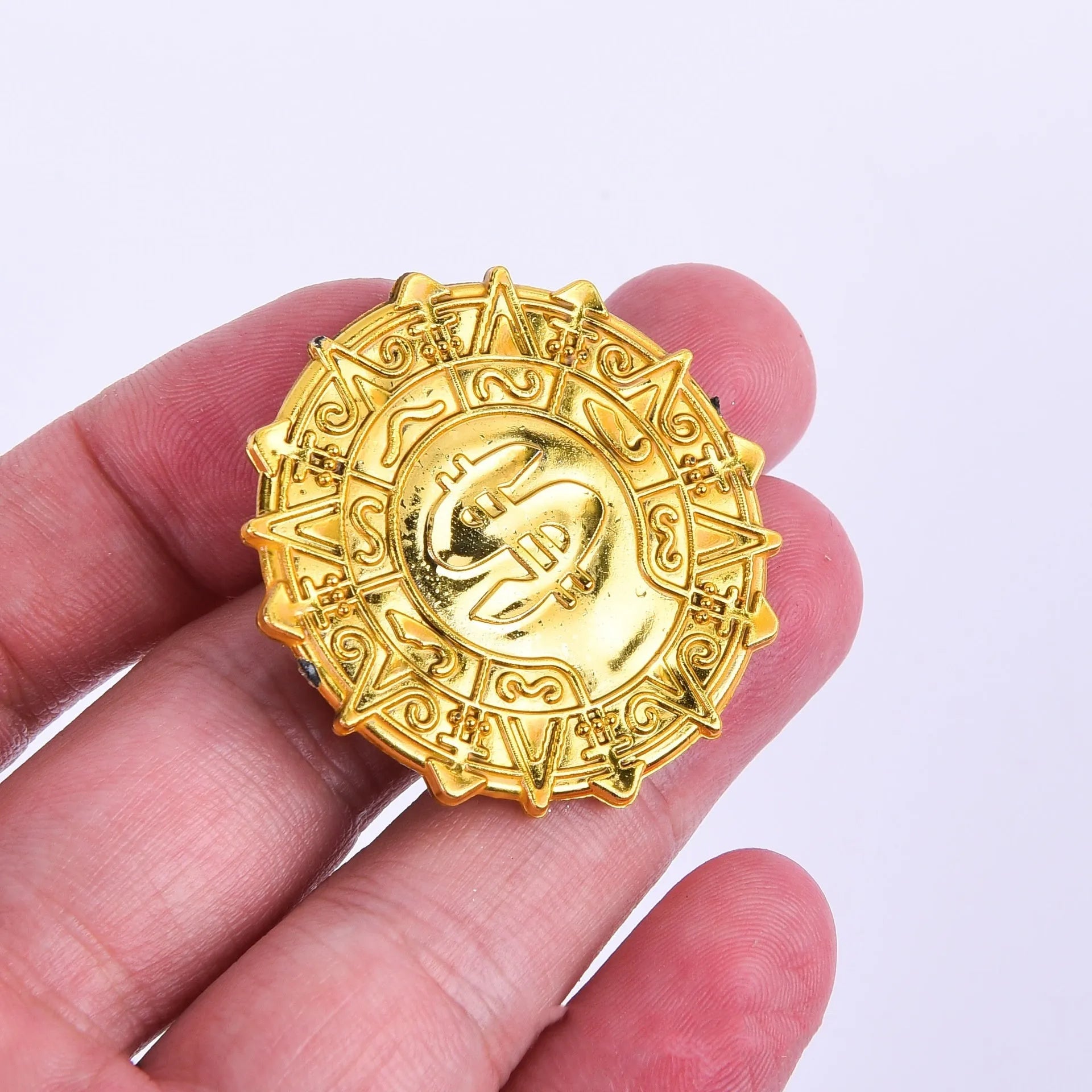Plastic pirate gold coin toy with pointed style design measuring 3.6cm across