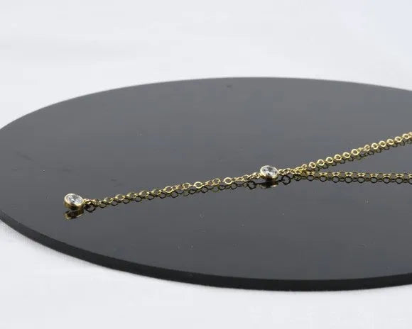 Gold colour alloy geometric pendant necklace with snake bone chain on display