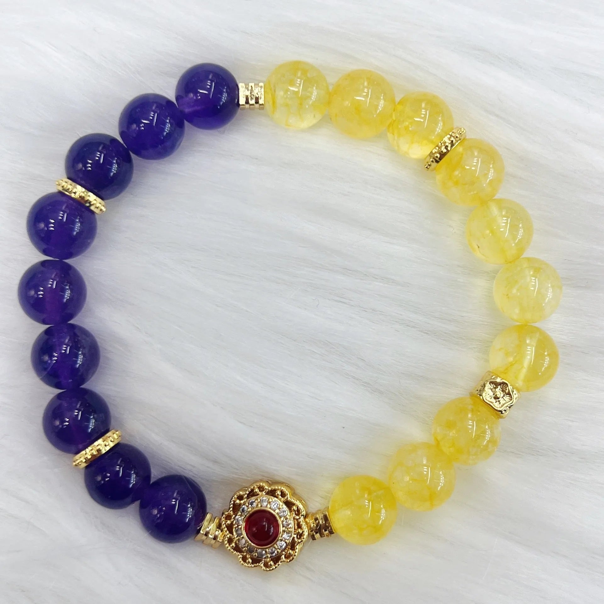 Handmade women's bracelet with yellow and purple amethyst crystals on wrist