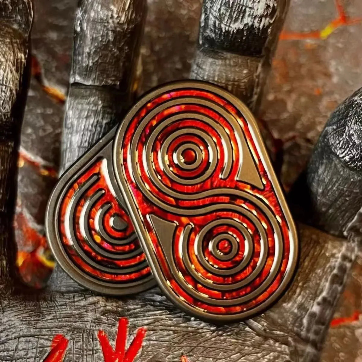 Stainless steel EDC hand push coin fidget toy in Agate Red colour on surface