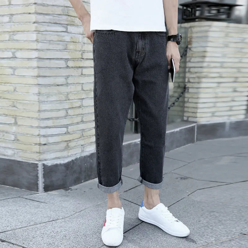 Men's black loose straight leg harem jeans on hanger