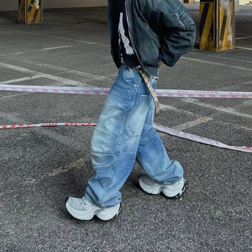 Blue baggy straight-leg jeans with a zip fly, shown in a washed white blue colour.