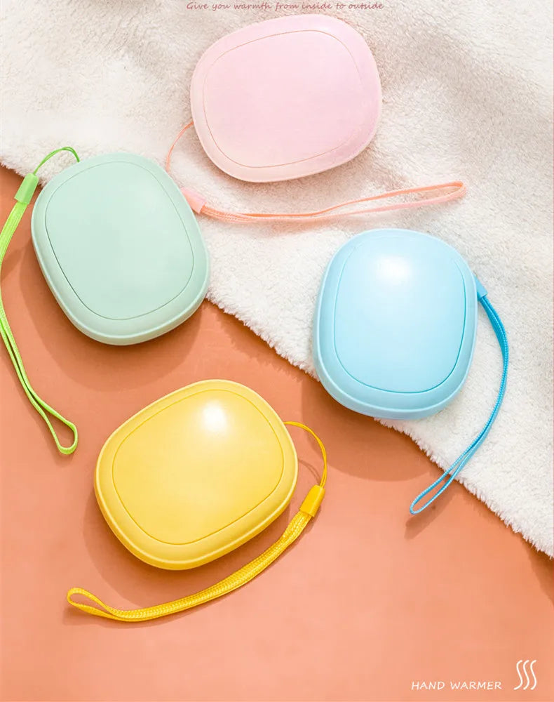 USB hand warmer in pink with three-gear temperature control and compact pebble design