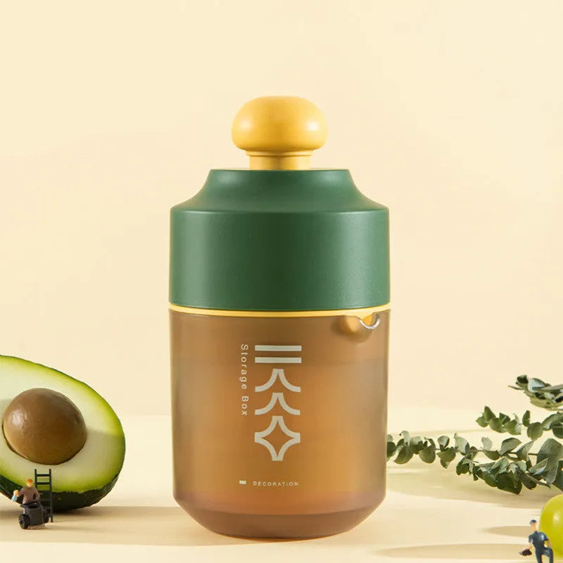 Green manual citrus juicer with lid on a kitchen countertop