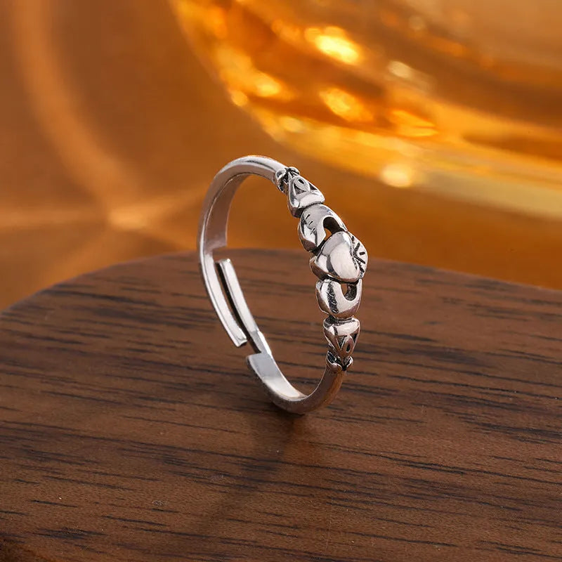 Retro silver women's open ring with a heart shape on a copper band.