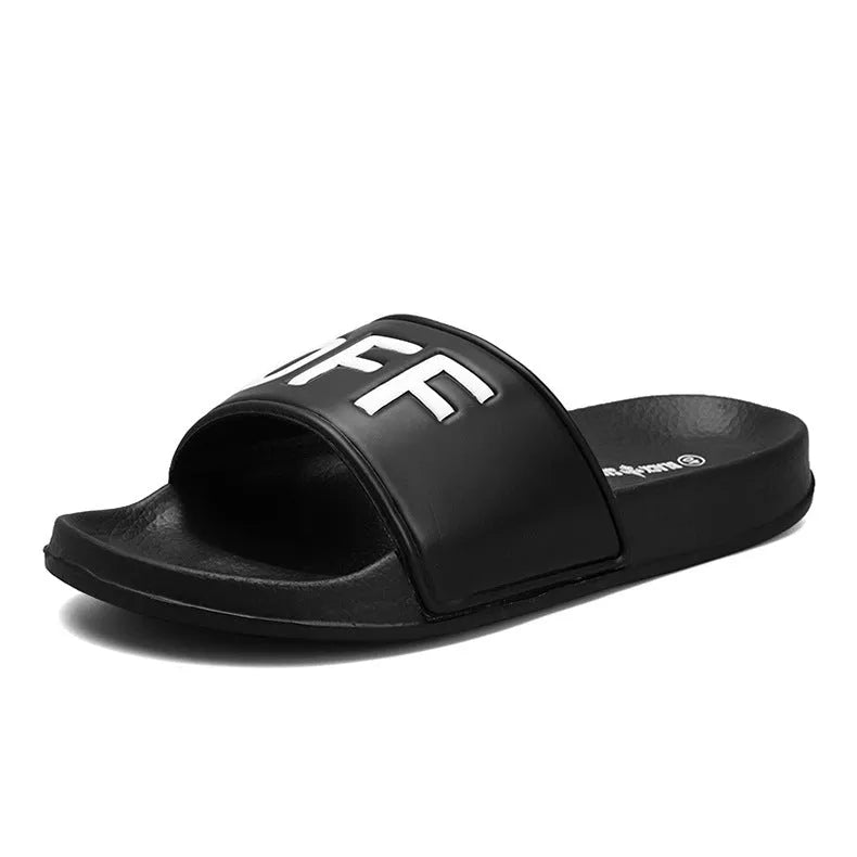 Men's large black and white open toe slippers with a rubber sole on a plain background.