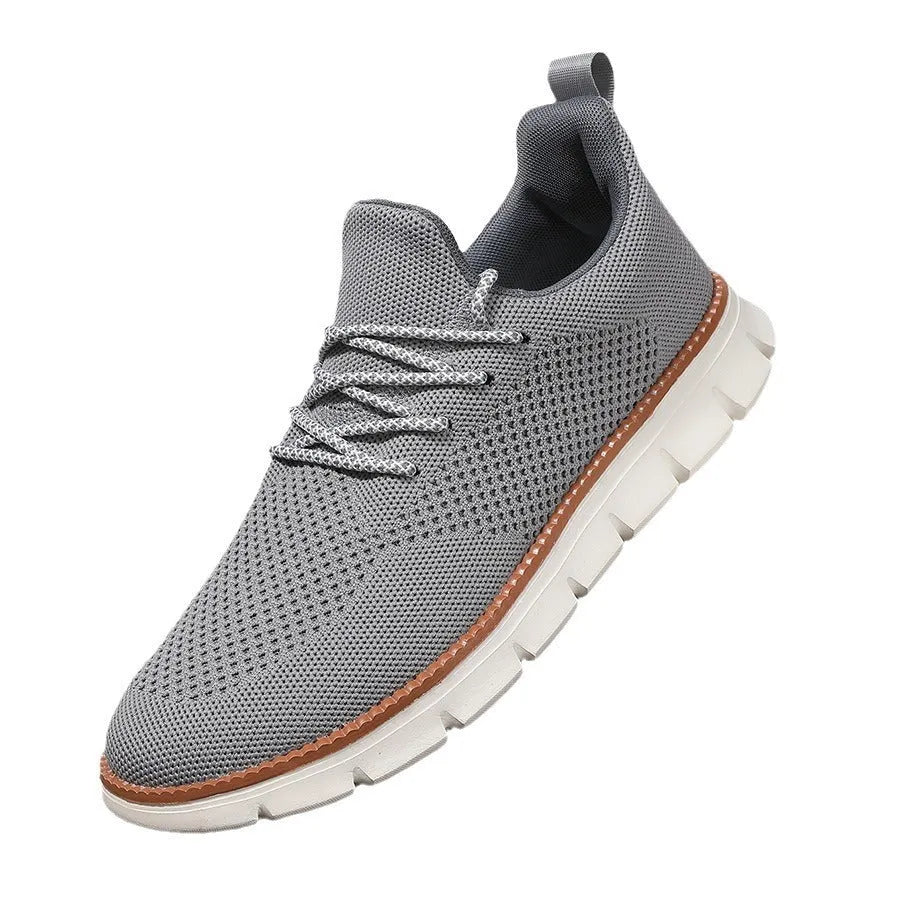 Men's grey and black low-heel casual sneakers with woven mesh fabric uppers and round toe.