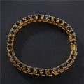 Men's silver geometric chain link bracelet with a row of sparkling clear rhinestones on a black background.