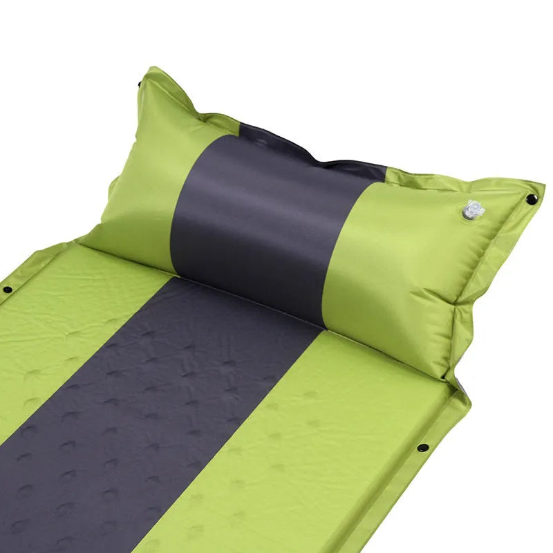 Outdoor automatic inflatable camping mat for one person with memory foam filling, blue and grey colour, shown on grass