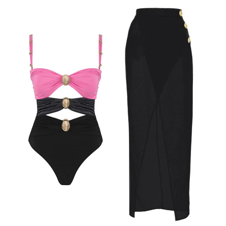 Women's solid colour one-piece swimsuit with detachable skirt and gold button detail.
