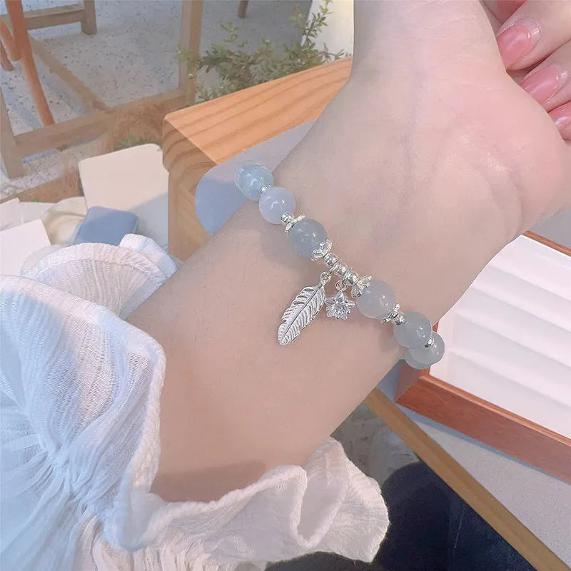 Glass crystal bead bracelet with blue moonlight colour and eight star design elements