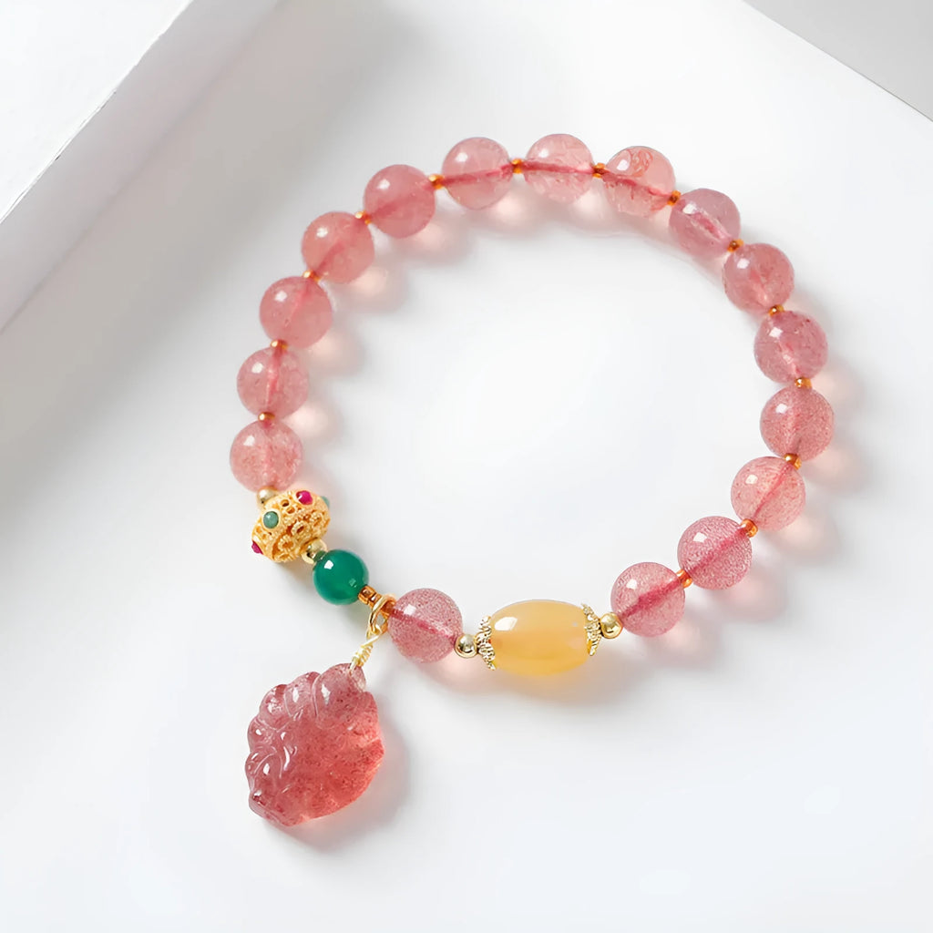 Women's crystal bracelet with nine tail fox design in polished natural strawberry quartz beads
