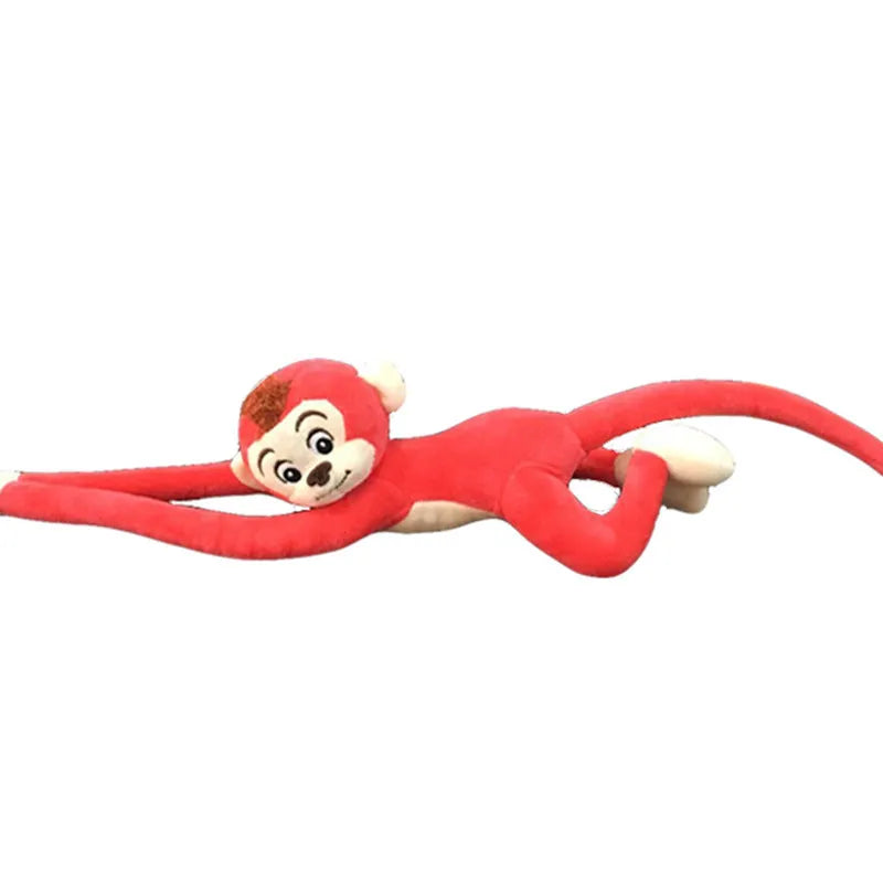Long-arm pink plush monkey toy hanging from a curtain as home decoration.