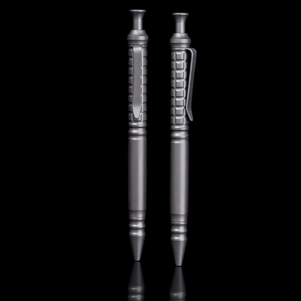 Gunmetal grey titanium alloy tactical pen with push-action button, shown in its gift box.