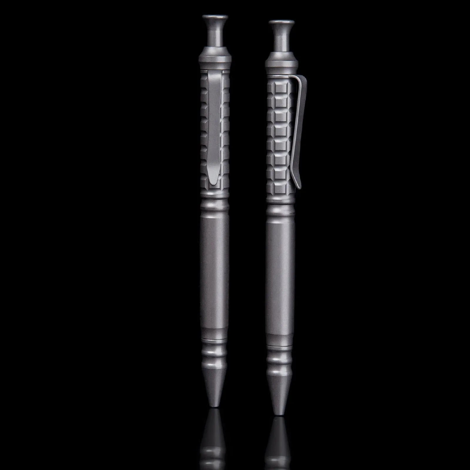 Gunmetal grey titanium alloy tactical pen with push-action button, shown in its gift box.