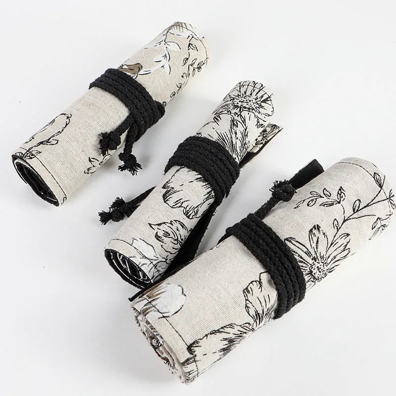 Black Peony printed canvas pencil roll bag open to show 24 or 72 holes for pencils on cotton hemp fabric.