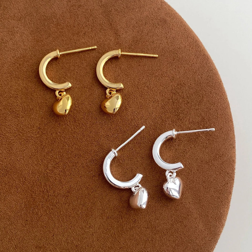 Copper heart-shaped earrings in gold and silver electroplate, available as ear clips or studs for women