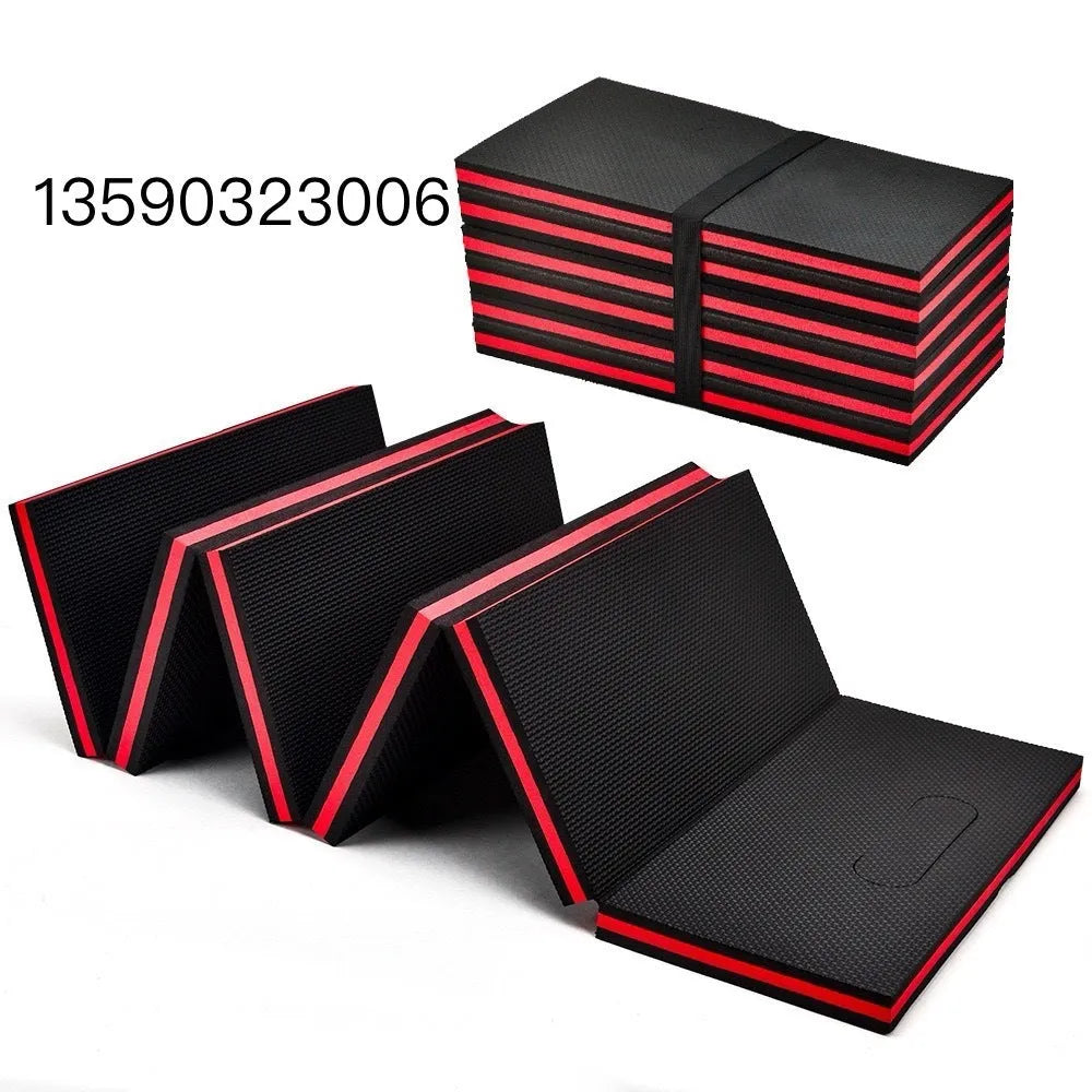 Grey EVA foam folding kneeling mat for car repairs, shown unfolded on a garage floor.