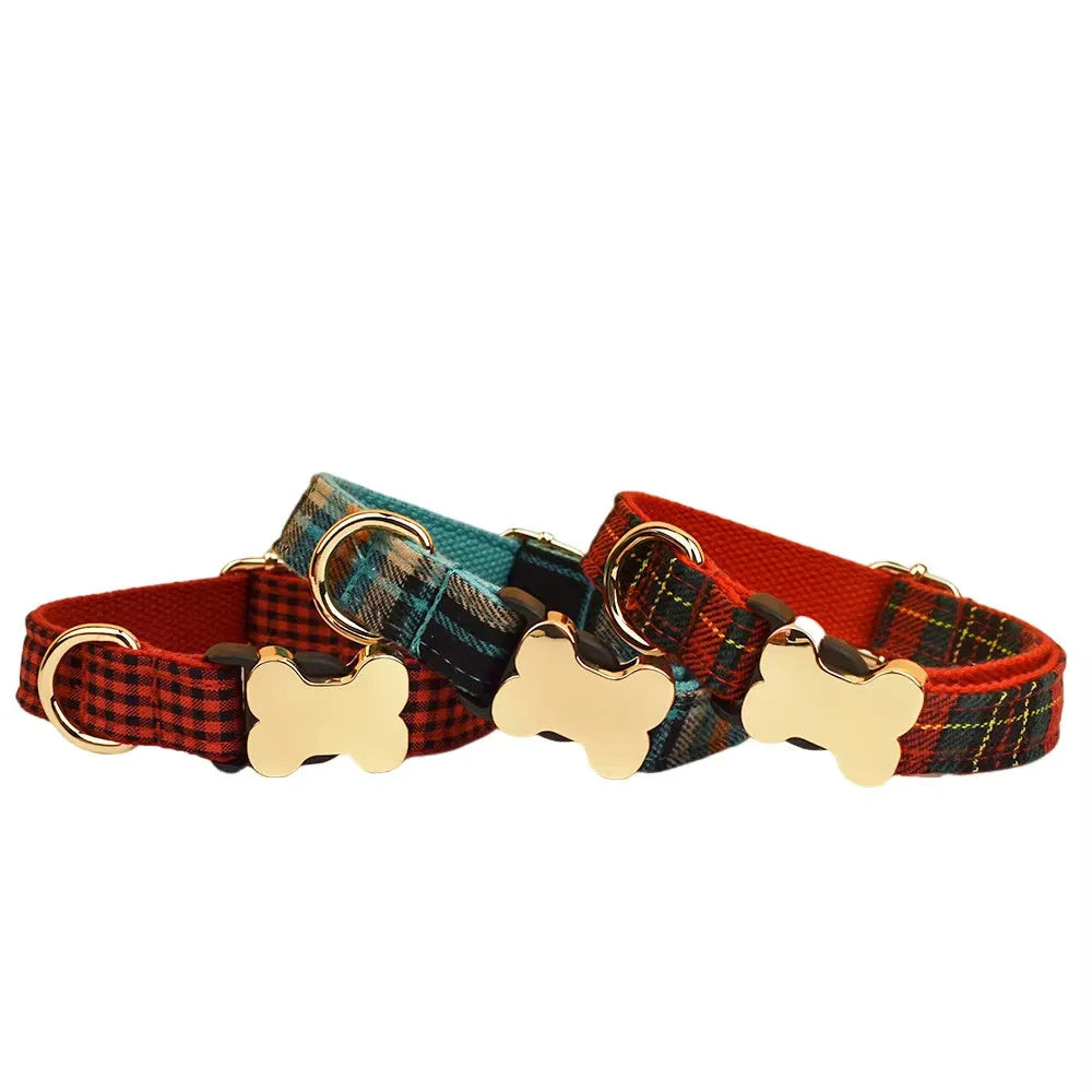 Flat nylon dog collar with grid print and a silver bone-shaped metal buckle on a green background.