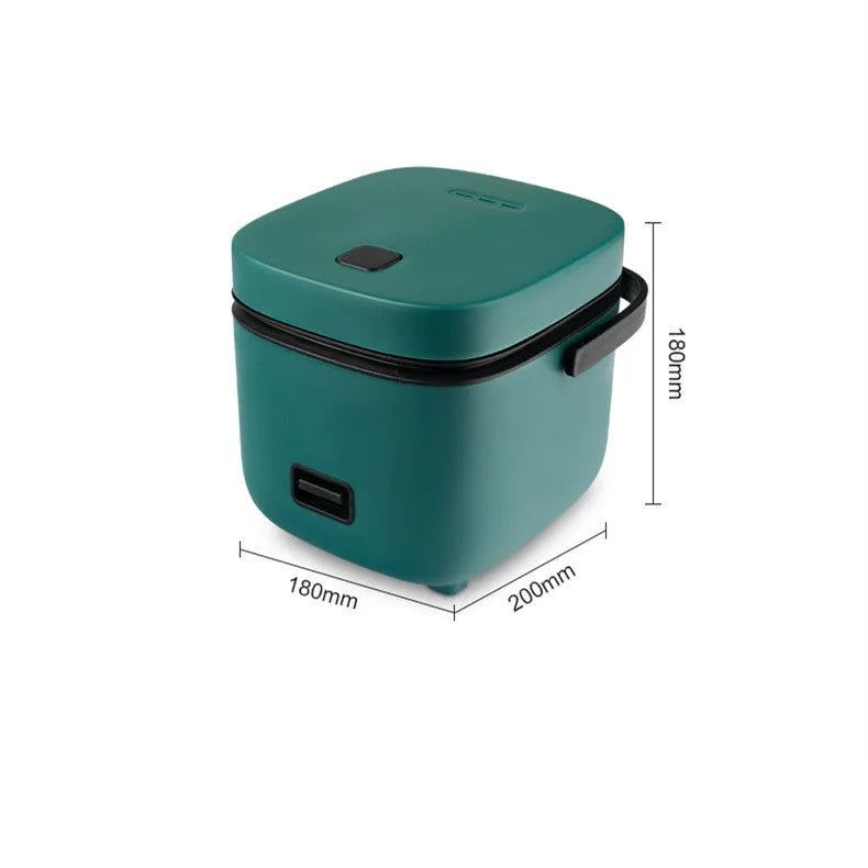 Green 1.2L mini rice cooker with metal body, button controls, and steaming plate on a worktop.
