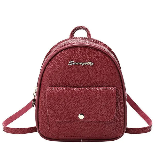 Compact black PU leather women's small backpack with a slim profile and zipper closure.