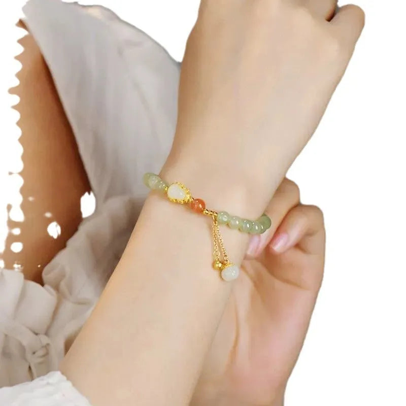 Jade women's bracelet with gold-plated gourd charm and fu character traditional design elements