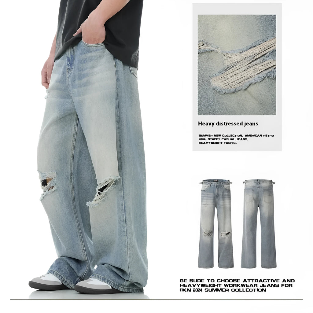 Blue men's straight-leg ripped jeans on a neutral background, showing zipper fly and cotton blend fabric texture.
