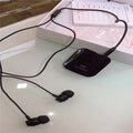 Black Bluetooth lavalier headset with earpiece and control unit, shown with packaging.