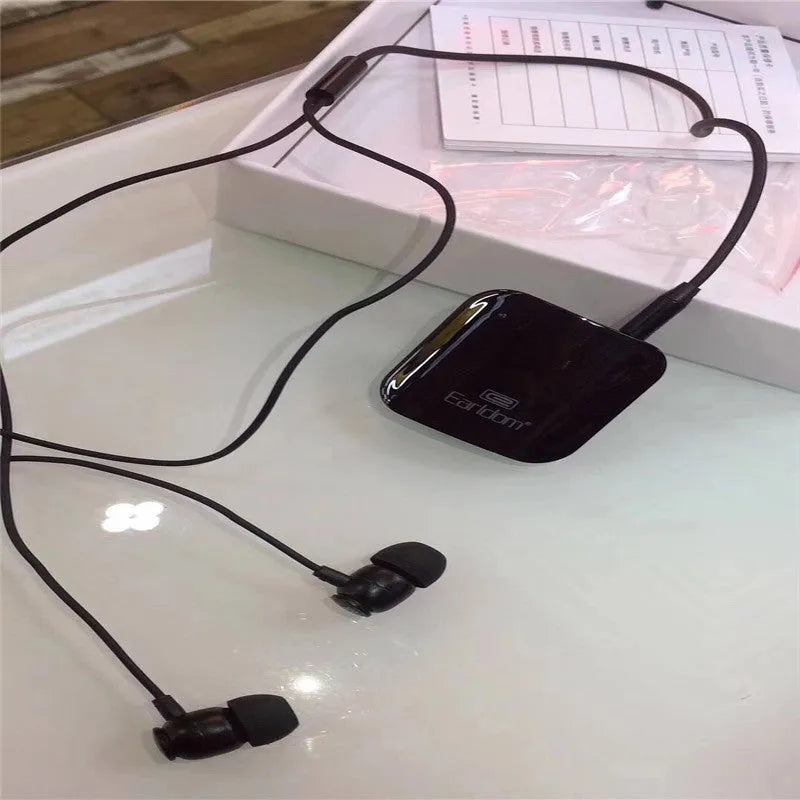 Black Bluetooth lavalier headset with earpiece and control unit, shown with packaging.